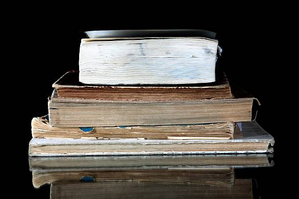 istock Stack of old books with vintage pages reflected 471591751