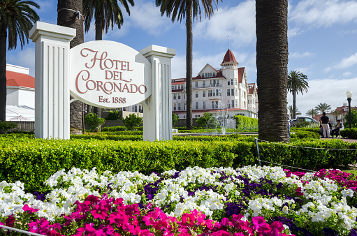 Coronado, United States - May 26, 2013: People meander about the entrance to the Hotel Del Coronado. The hotel, which originally opened in 1888, was the largest resort hotel in the world at the time and currently has 680 rooms. 
