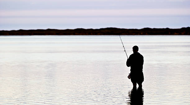 istock Silhouette of a Fisherman 471592168