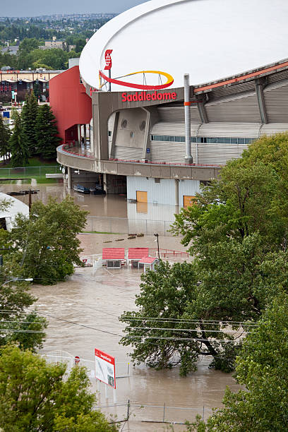 Calgary 2013 Flood Calgary, Canada - June 21, 2013: The historic 2013 Calgary Flood will be one of Canada's costliest natural disasters. Numerous buildings in the downtown core saw considerable damage. Pictured is the Calgary Saddledome, which saw water reach the 14th row of the arena. scotiabank saddledome stock pictures, royalty-free photos & images