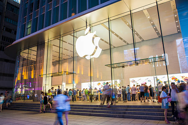 Shanghai, Сhina - Jun 21, 2013: Apple store seen from the outside on Nanjing Road, downtown Shanghai. This store is the largest Apple retail store in Shanghai, and the 4-floor store in always crowded with people. There are many people inside and outside the store. Some people are walking on the Nanjing Road Pedestrian Street, which is Shanghai's most famous shopping street and has numerous stores for shopping.