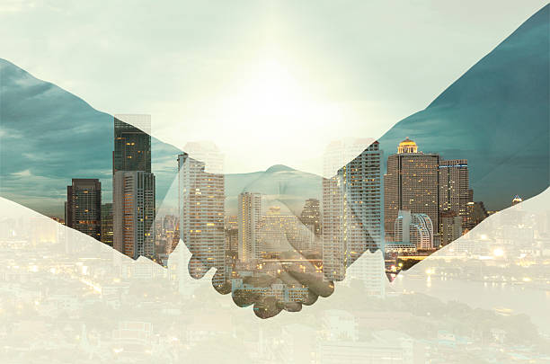 istock double exposure handshake between businessman on a city background 471592446