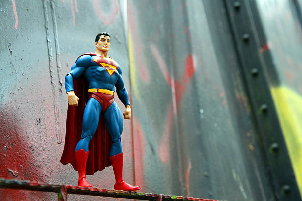 Superman and Bent Metal Whistler, Canada - June 15, 2013: An action figure model of Superman, sculpted by Paul Harding and released by DC comics, against a bent metal. action figure photos stock pictures, royalty-free photos & images