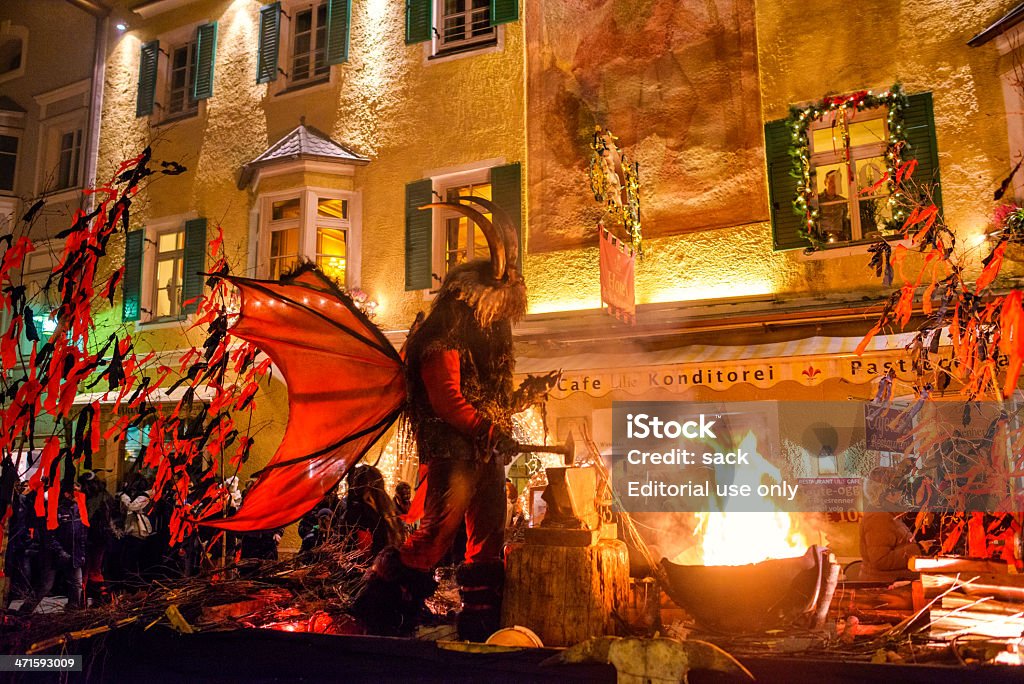 Sterzing on Fire during Tuifltog (Krampus Night) Sterzing/Vipiteno, South Tyrol, Italy - December 5, 2012: Scary devil on a parade car at „Tuifltog“ (Devils night or Krampus Night) in the streets of Sterzing (ital. Vipiteno), South Tyrol. As in many parts of Tyrol in Austria, southern Bavaria and South Tyrol, the day before the Feast of St. Nicholas, Saint Nicholas appears in devilish companion on the streets. While Saint Nicholas rewards the well-behaved children with gifts, Krampus – a beast-like creature – in contrary, punishes naughty, bad-behaved children. During a spectacular parade at night, costumed devils appear in the streets of Sterzing, terrifying child and adult alike -- yelling, roaring, whipping with birch brooms and carrying bad behaving people away in cages. The traditional "Nikolaus- and Krampusumzug" (St. Nicolas and Krampus Night) takes place in the beautiful town of Sterzing, South Tyrol every year on December 5.  Krampus Stock Photo