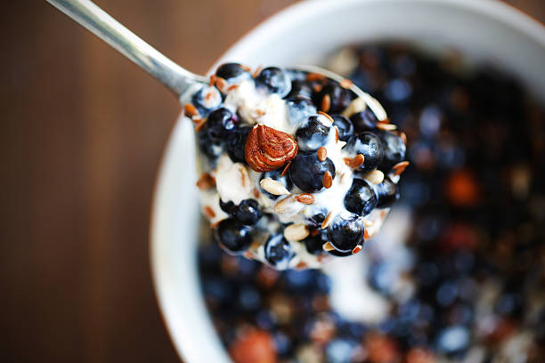 Blueberries with nuts, seeds and yoghurt for breakfast stock photo