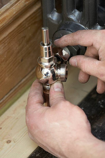 istock Plumber Fitting A New Radiator In House 471593543