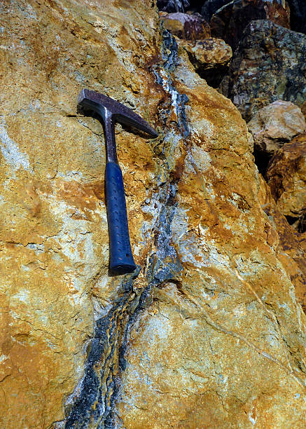 Sphalerite and quartz vein in quarry with geological pick.