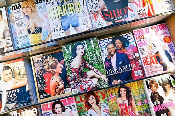 Stack of magazines New York City, USA - June 22, 2013: Stack of popular magazines on the outside of the street side newsstand on Broadway Upper West. Vogue, Cosmopolitan, Glamour and Essence can be seen. newspaper titles stock pictures, royalty-free photos & images