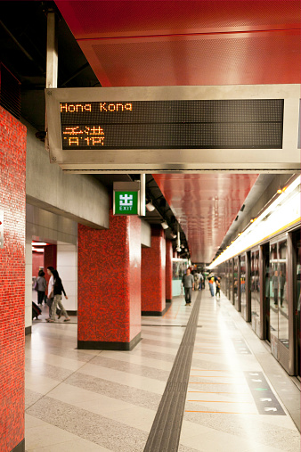 Hong Kong - April 16, 2011: People waiting for train  MTR underground in the Hong Kong. Mass Transit Railway (MTR) is the rapid transit railway system in Hong Kong that is a common mode of public transport with over four million trips made in an average weekday.