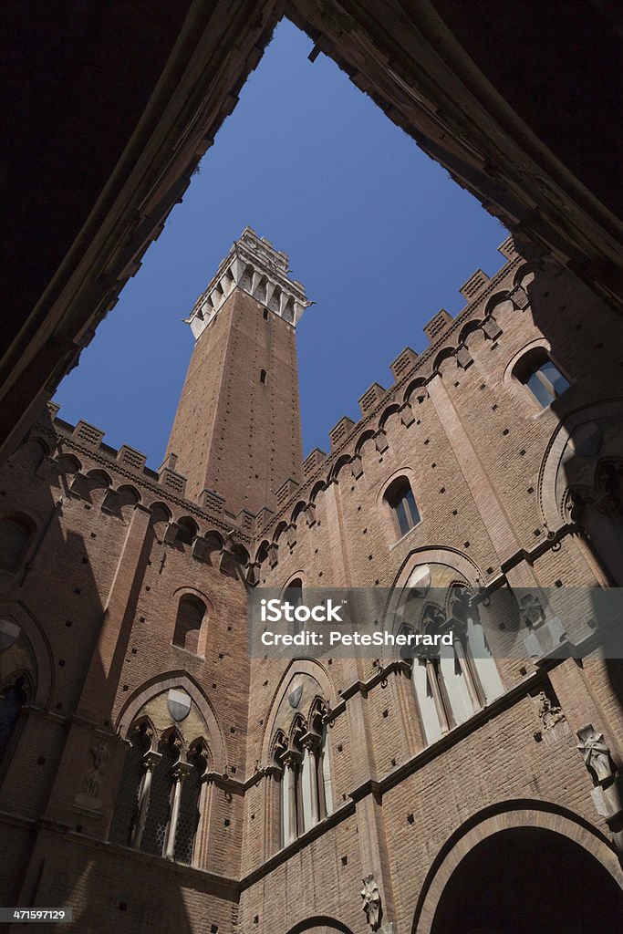 Mangia Tower in the Piazza del Campo, Siena, diagonal View of Torre del Mangia, Piazza del Campo in Siena, taken from the Palazzo Pubblico. Architecture Stock Photo