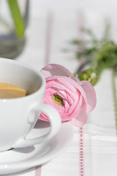 istock Pink Persian buttercup and cup of coffee 471597268