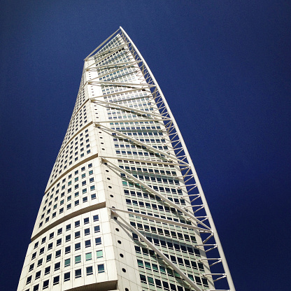 Malmo, Sweden - June 18, 2013: The twisted skyscraper Turning Torso seen from below on a sunny and warm summer day. Turning Torso is the most prominent landmark in Malmo.