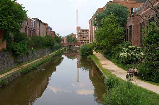 Washington DC, USA - June 13, 2013.  A young couple walks along the towpath of the historic C&O canal in the historic Georgetown district.