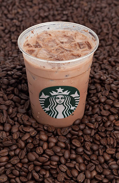 Taipei, Taiwan - February 3, 2013: This is a studio shot of a cup of iced Starbucks coffee on top of a pile of Starbucks brand coffee beans.