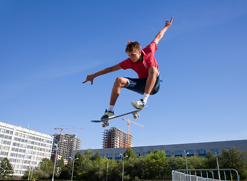 cool skateboard is jumping high in air