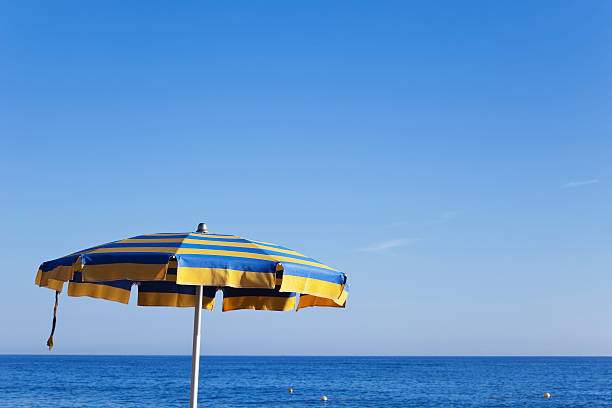 istock Italy, Liguria, sunshade at beach, blue sky 471599310