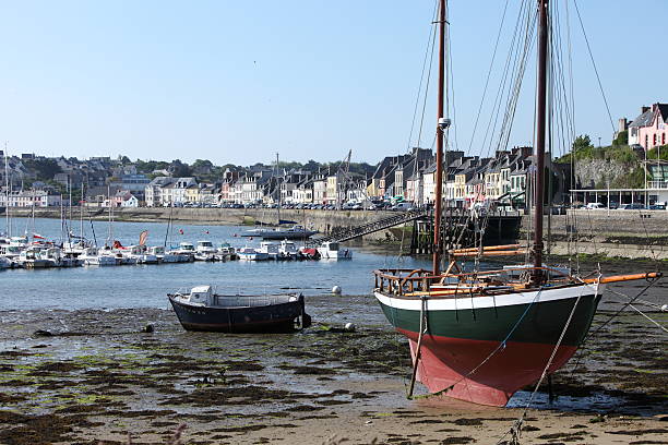 Camaret, France - June 04, 2013: old wooden fishing boat moored at Camaret harbor, Brittany, France. City of Camaret on the background.