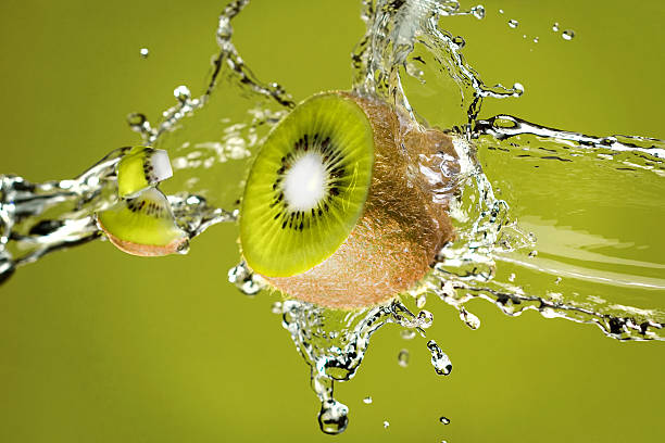 Kiwi in water splash stock photo