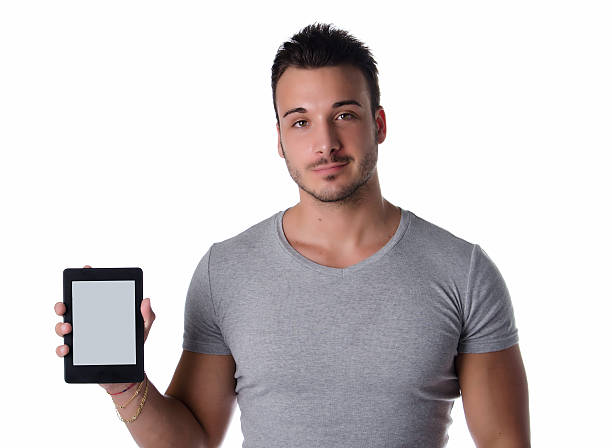 istock Attractive young man holding and showing ebook reader 471600025