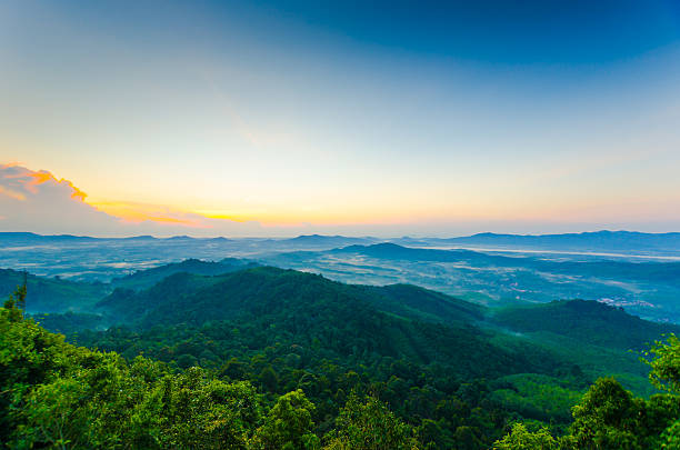 Beautiful sunshine at misty morning mountains .