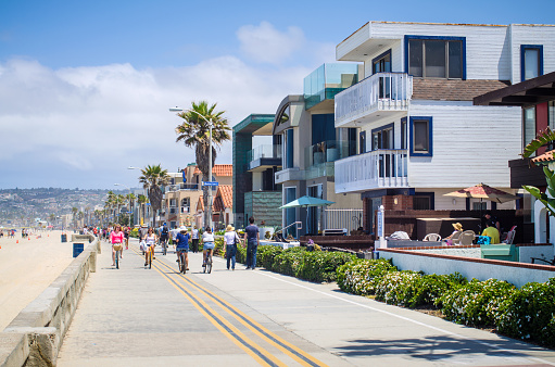 San Diego, United States - May 27, 2013: People meander about Ocean Front Walk adjacent to the sandy beach of Mission Beach during the Memorial Day weekend.  