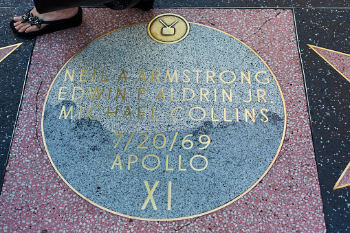 Hollywood, California, USA - May 11, 2013: Of all the marble and brass stars on the Hollywood Walk of Fame, just one is not a star. It is a moon shaped memorial to the astronauts of the first moon landing