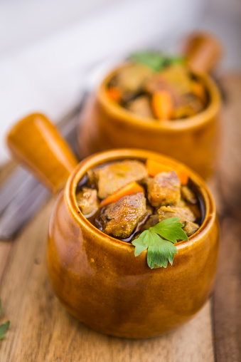 Portion of traditional beef stew with carrots. studio shot