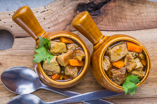 Portion of traditional beef stew with carrots. studio shot