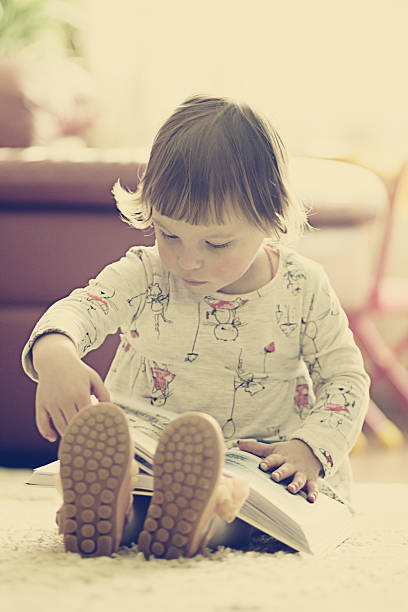 istock little girl reading a book 471604982