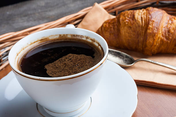 istock Cup of coffee and a croissant. 471605714