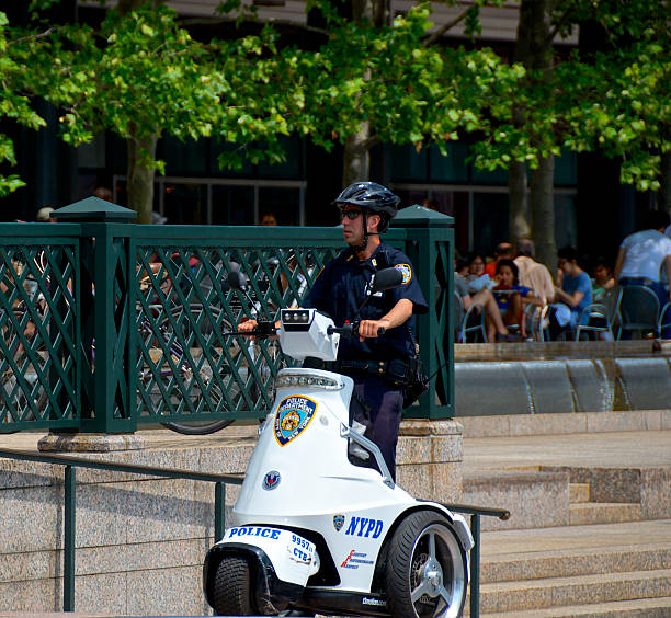 Nypd Officer T3 Patroller Scooter Lower Manhattan Nyc Stock Photo - Download Image Now - iStock