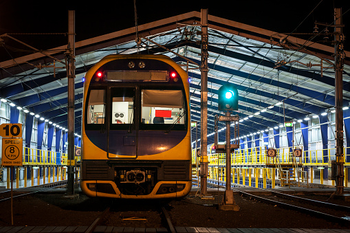 Electric Commuter train inside a maintenance shed, at night