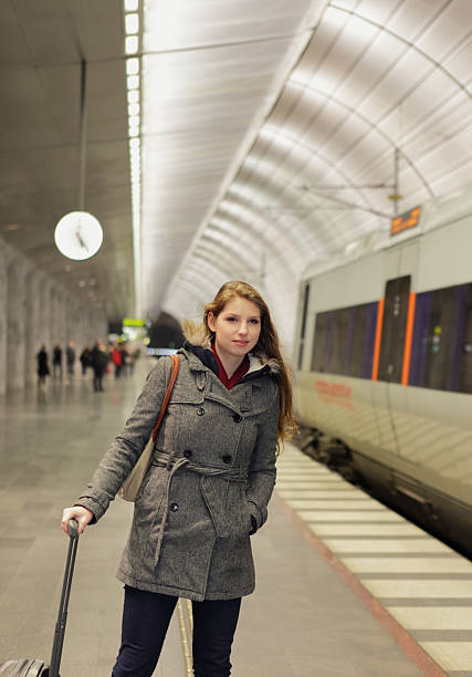 istock woman at railway station 471607215