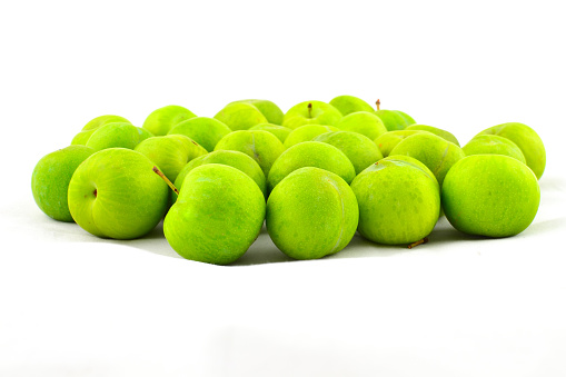 green plums with white background