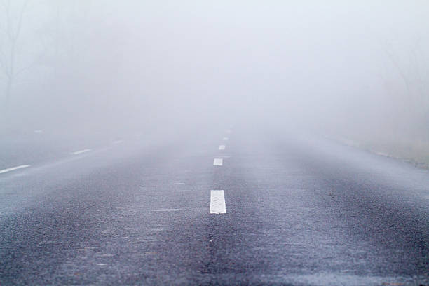 istock Asphalt road in an autumn fog 471608319