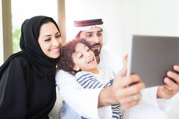 istock Happy Arabic family using a tablet together 471609076