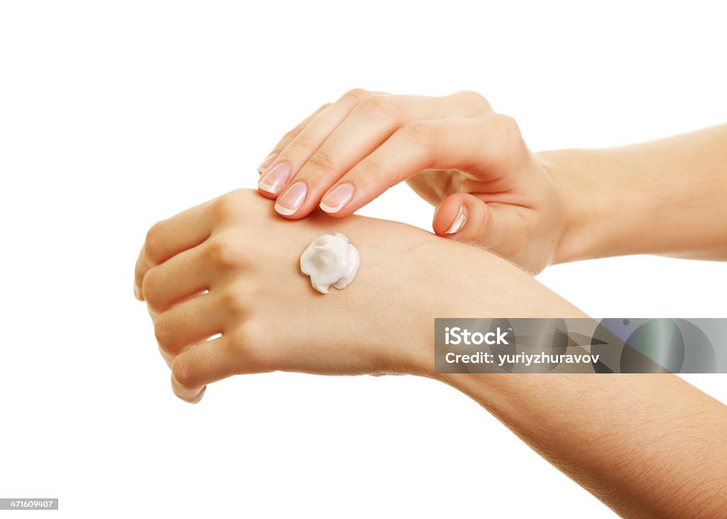 beauty girl applying some white lotion on her hand Adult Stock Photo