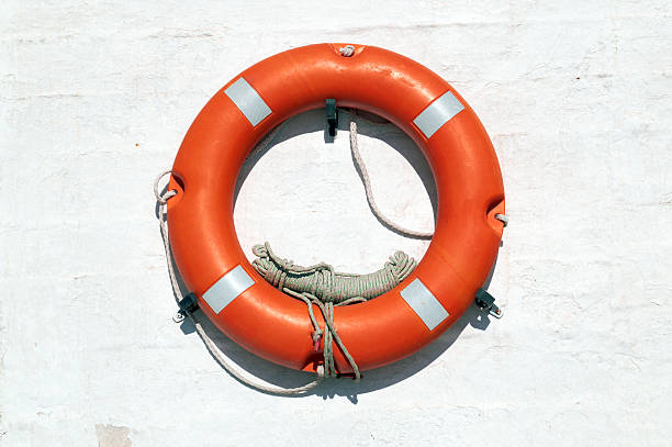 istock Red Life Buoy hanging on the wall 471609447