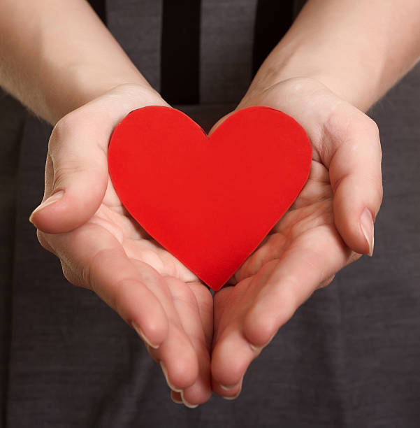 istock red paper heart on the hands 471609475