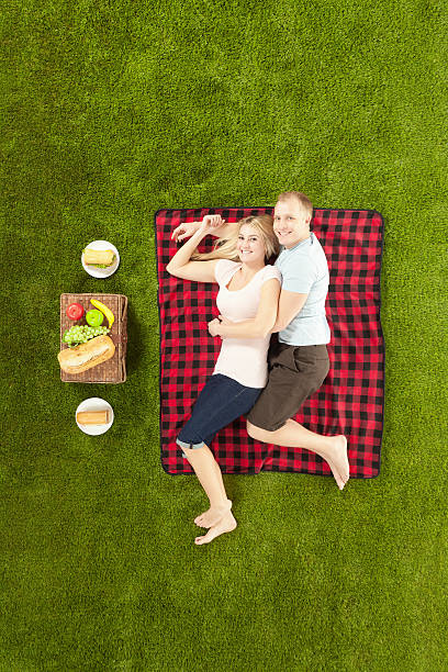 istock Top view of young couple sleeping at picnic 471611479