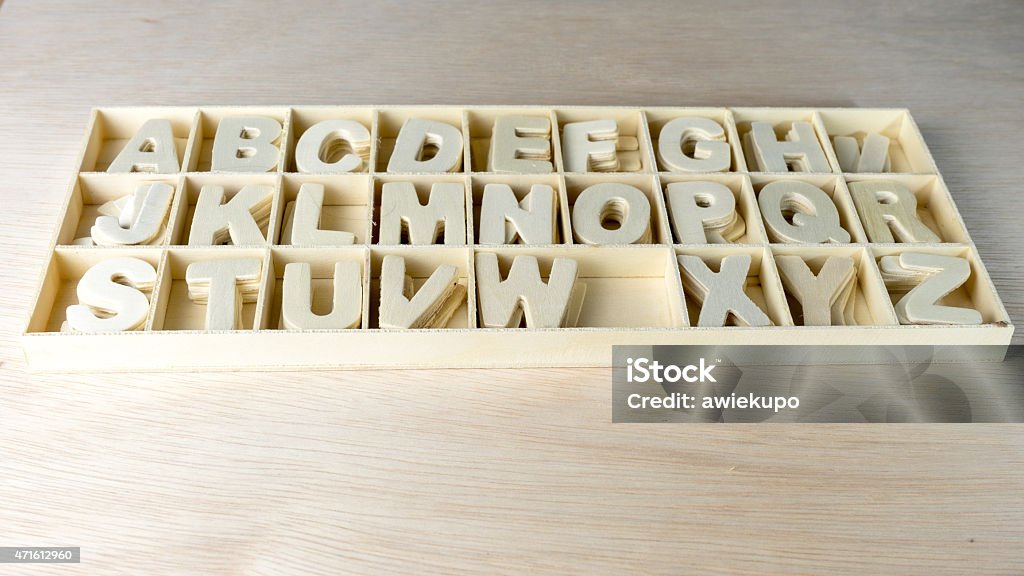 Unpainted wooden alphabet letter set in boxes of compartment Clean and unpainted wooden alphabet letter set in boxes of compartment. Concept of back to school. Slightly defocused and close-up shot. Copy space. 2015 Stock Photo