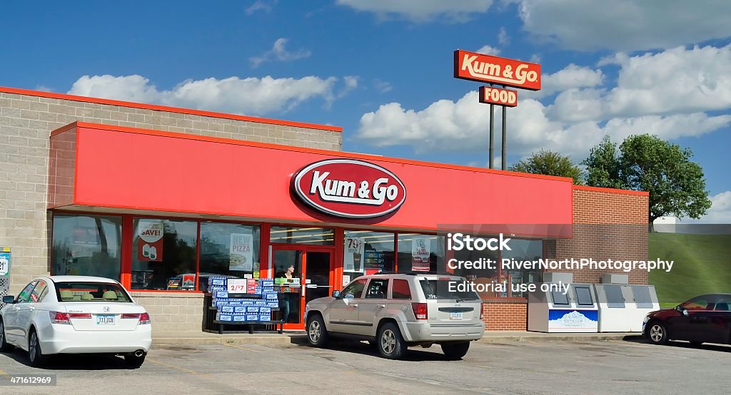 Kum & Go Service Station Walton, Iowa, USA - June 28, 2013: A person leaving the Kum & Go service station in Walton, Iowa. Kum & Go is a chain of convenience stores that operates over 400 locations, primarily in the midwestern states. Gas Station Stock Photo