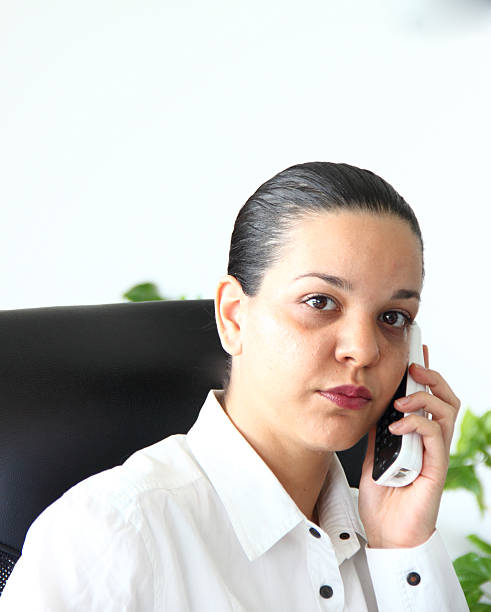 istock Girl with phone in her office 471613295