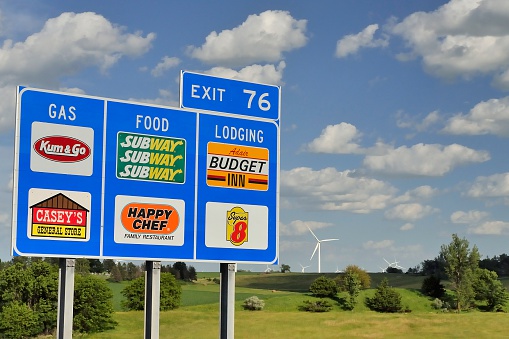 Adair, Iowa, USA - June 28, 2013: An exit sign on Interstate 80 leading to gas, food, and lodging.