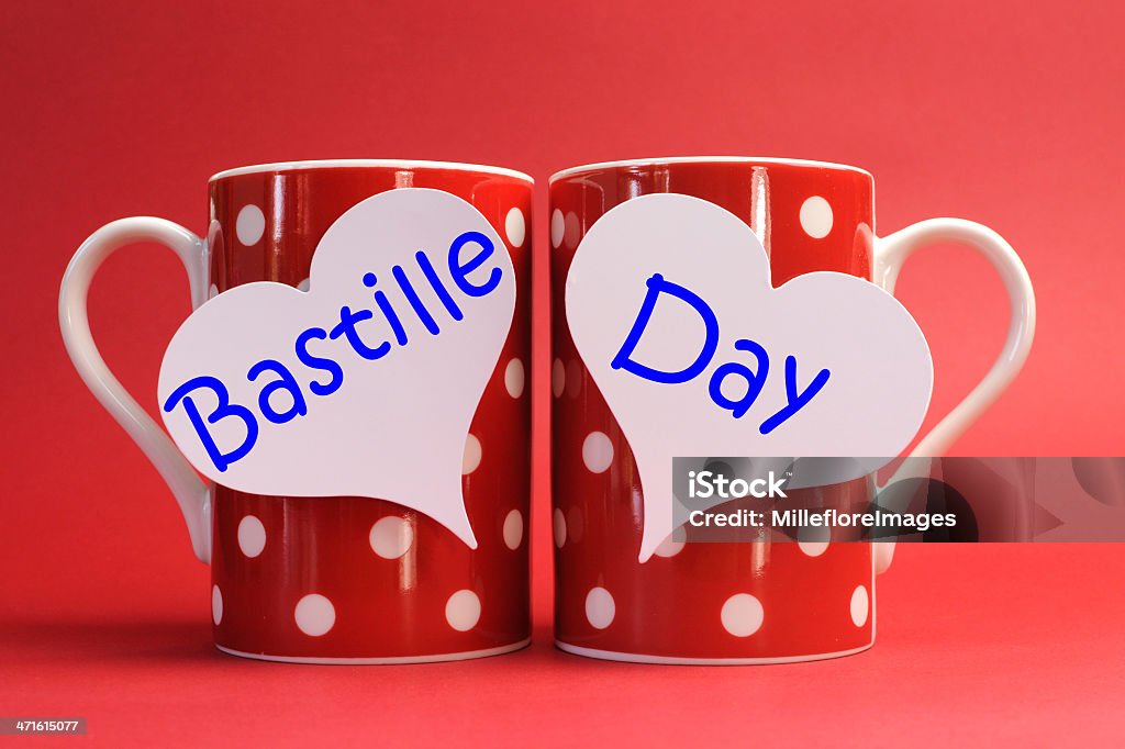 Share a cup of coffee for France Bastille Day. Share a cup of coffee for France National holiday calendar, 14 July, Fourteenth of July, Bastille Day, with two red polka dot coffee mugs and white heart tags with Bastille Day greeting against a red background. Bastille Day Stock Photo