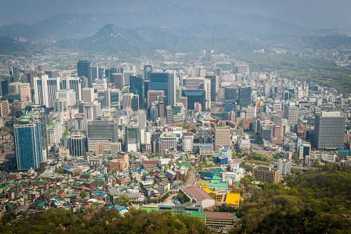 Aerial vista across the skyscrapers and landmarks, mountain parks and crowded suburbs of central Seoul, South Korea. ProPhoto RGB profile for maximum color fidelity and gamut.