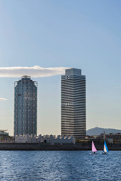 Barcelona - sail boats passing by along Barceloneta beach stock photo