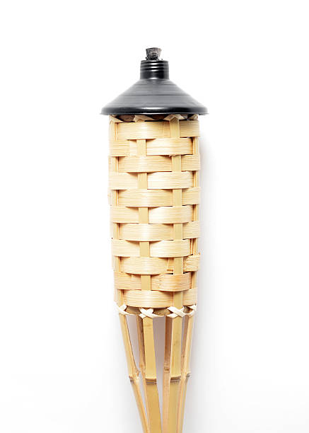 Tiki Torch Close up of a Tiki Torch on a white background with shadows.   tiki torch stock pictures, royalty-free photos & images