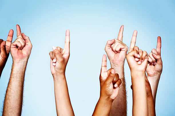 istock Up there! Look! Many hands pointing upwards energetically 471618541