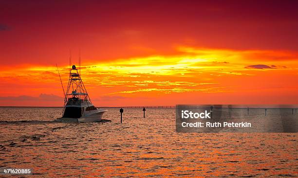 A Ship At Sea In The Sunset With Orange Skies Stock Photo - Download Image Now - Destin, Fishing, Sunset